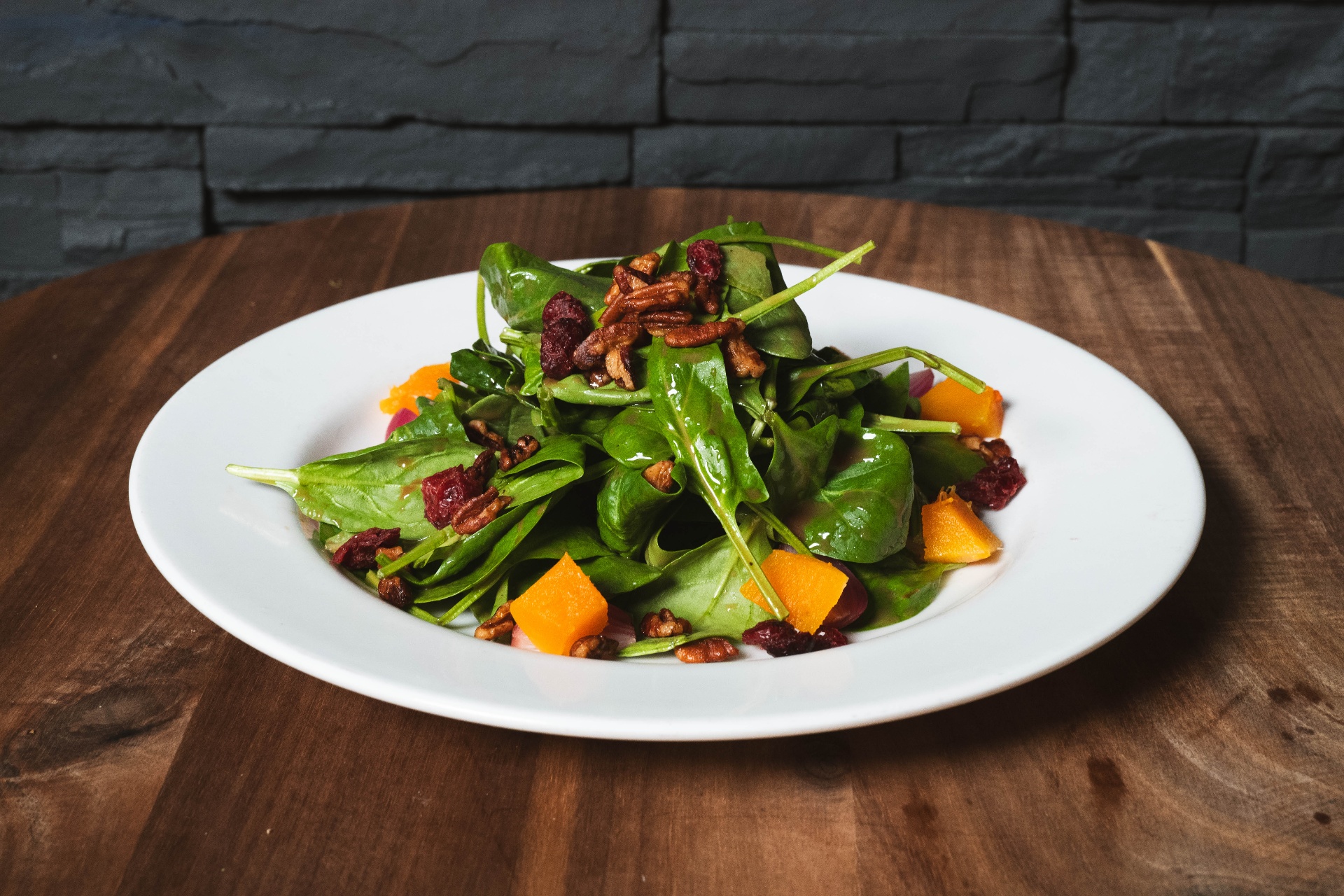 Spinach salad with pecans, cranberries, and squash
