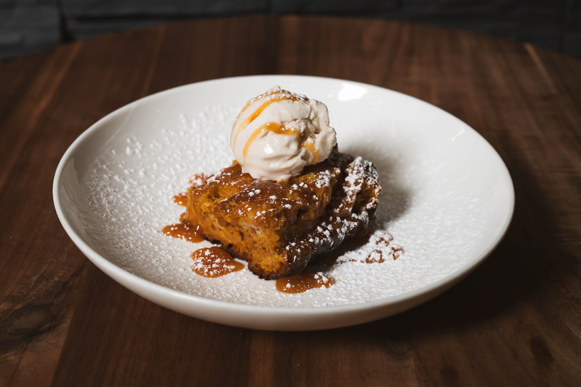 Warm bread pudding with caramel sauce and vanilla ice cream